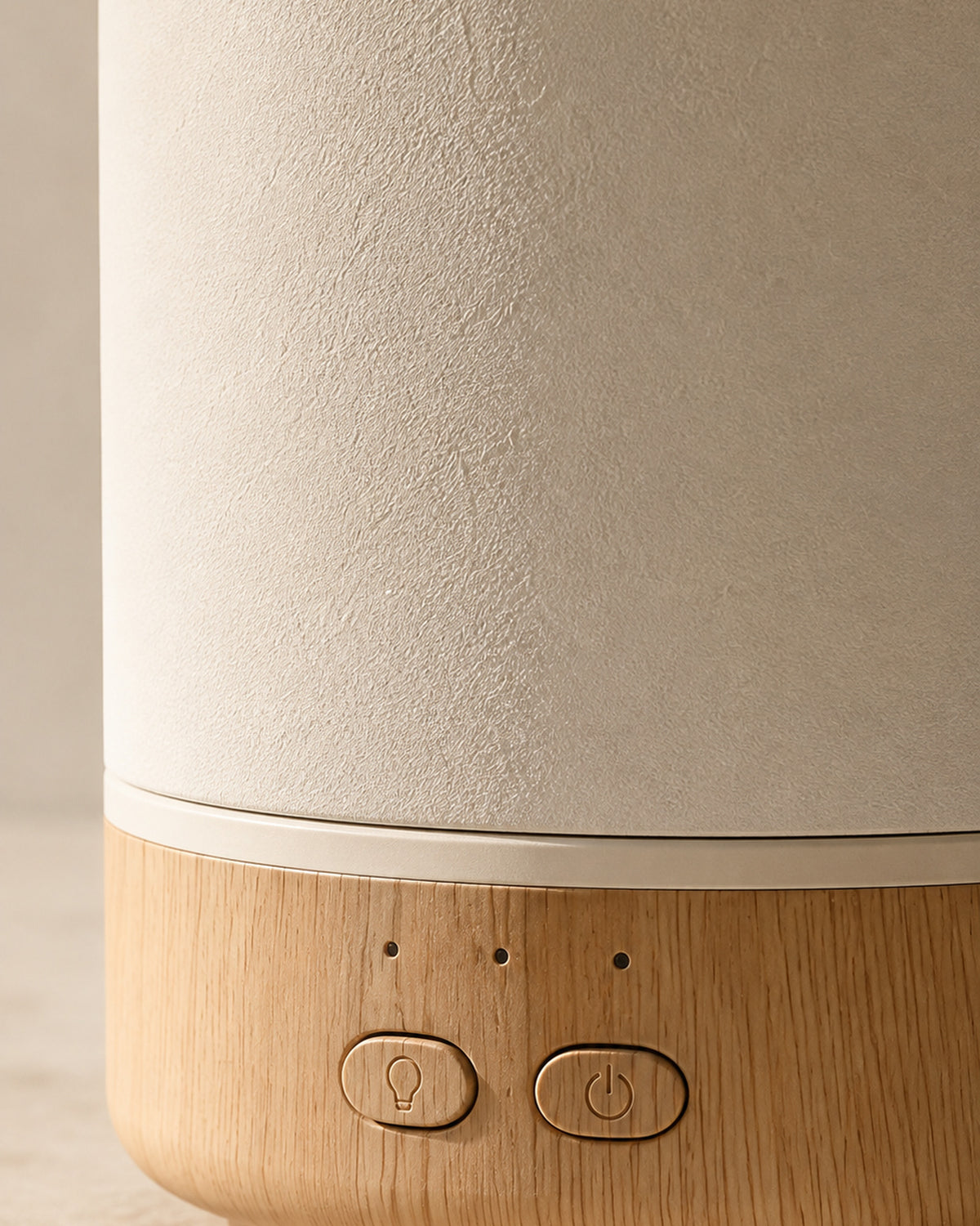 Close detail of the two controls and the groove where the ceramic meets the wood base
